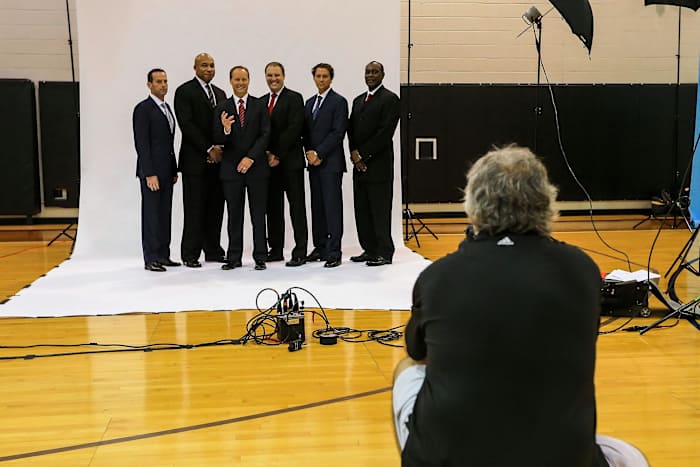Atlanta Hawks head coach Mike Budenholzer (third from left) and his staff pose for team photographer Scott Cunningham during media day at Philips Arena.
